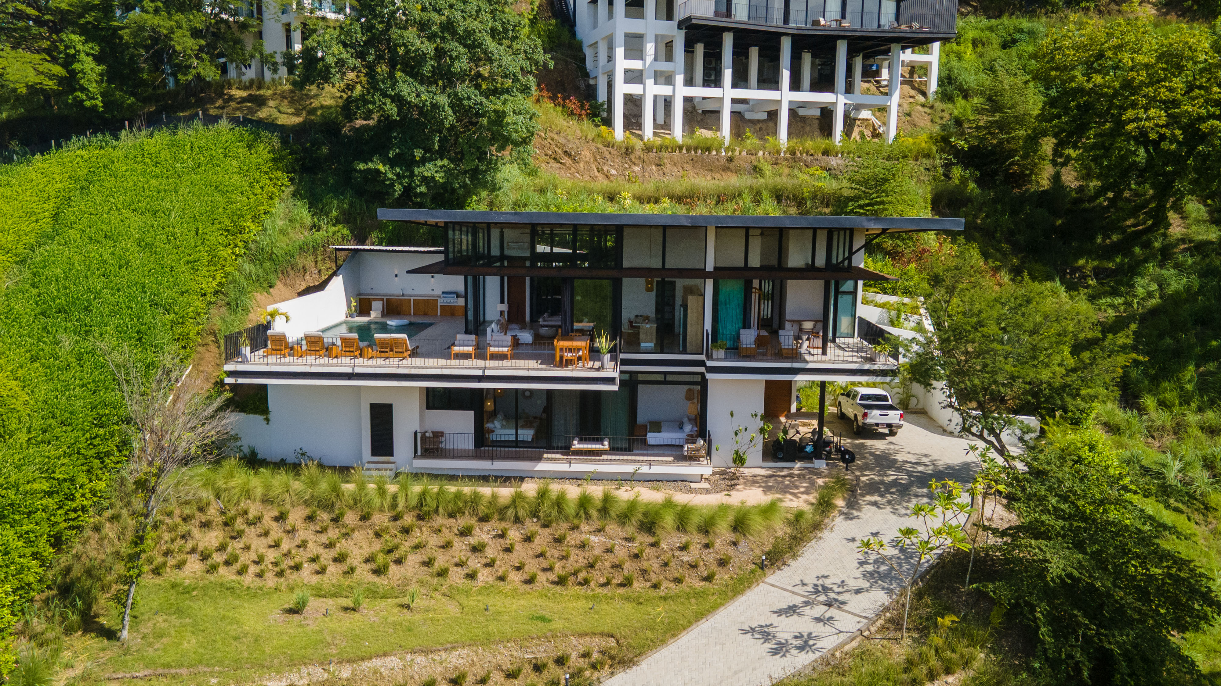 Hilltop home with panoramic views and lush surroundings