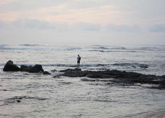 Fisherman checking the ocean at Anahola