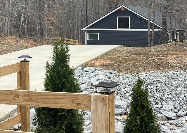 Long new driveway with a cabin tucked in the woods