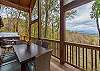 Back deck with outdoor furniture and hot tub.
