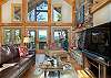Living room with mountain views and wood fireplace
