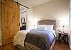 Downstairs bedroom with queen bed and full bath.