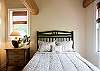 Upstairs bedroom with queen bed and full bath.