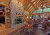 Spacious living area w/ wood fireplace and flat screen TV.
