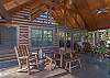 Partially covered back deck with rockers and table (seating for