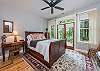 Bedroom with queen bed and doors to outdoor terrace.