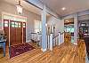 Entry way opens into living area, with stairs to lower level.