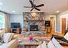 Living area with flat screen TV and wood burning fireplace.
