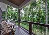 Deck wraps around to front of the house, overlooking front yard.