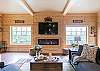 Den includes a 60" flat screen TV and electric fireplace.