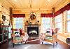 Sunroom features an electric fireplace.