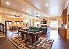 Game room features pool table, foosball, Pac-Man and poker table