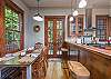 Living area opens up into dining area and kitchen, with doors to