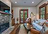 Custom stone, wood burning fireplace and flat screen TV.