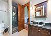Master suite with walk-in shower and soaking tub.