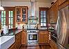 Fully equipped kitchen with gas range.