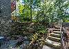 Stone steps leading down to lower level patio and fire pit area.