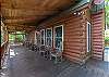 Covered front porch w/ rocking chairs.