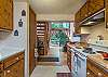 Galley kitchen opens to living room