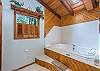 Large soaker tub in main level bath.