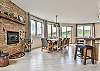 Main level great room w/ wood fireplace off kitchen.