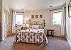 Upper level queen bedroom w/ en suite (shower/tub combo).