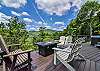 Lower level deck w/ fire table & hot tub.
