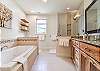 En suite bathroom on main level w/ soaking tub & walk-in shower.
