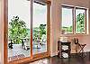 Doors leading out to lower level deck w/ fire table & hot tub.