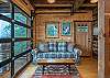 Queen sleeper sofa and garage door that opens onto the porch