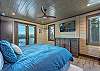 Main level bedroom w/king bed, smart TV, and patio access