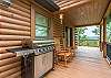 Rocking chairs near the gas grill on the porch