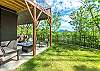 Fenced-in yard & lower level patio w/fire table & hot tub