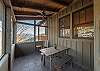 Main house screened-in porch w/dining table & views