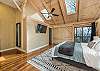 Main level bedroom w/California king bed, smart TV & deck access