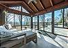 Enclosed sunroom offers quick access to the deck
