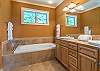 En suite bath w/soaking tub, walk-in shower, and double vanity