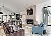 Luxe living room w/floor-to-ceiling woodland views