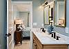 En suite bath w/double vanity & sleek walk-in shower