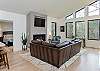 Luxe living room w/floor-to-ceiling woodland views