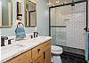 En suite bath w/double vanity & sleek walk-in shower