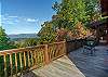Rocking chairs & charcoal grill on the wraparound deck