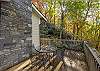 Dining table on main level deck overlooking creek