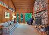 Den on main level w/ wood fireplace and doors out to deck.
