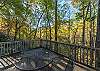Dining table on main level deck overlooking creek.