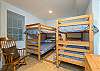 Bedroom on lower level w/ 2 sets of bunk beds.