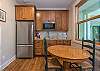 Apartment kitchenette & dining area w/ seating for 2.