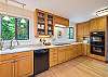 Kitchen w/ dishwasher and coffee maker.
