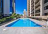 Cool off in the Four Paddle’s community pool, surrounded by palm trees and the Waikiki skyline—a serene spot to relax after exploring Oahu.