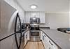 Cook comfortably in a sleek full kitchen with stainless-steel appliances, bright cabinetry, and plenty of counter space—ideal for relaxed meals in Waikiki.